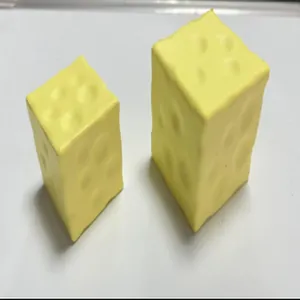 Detail showing two yellow cheese-shaped slow rebound squishy toys for stress relief