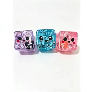 Three cute Halloween ghost square squeeze toys featuring glowing snowflake glitter