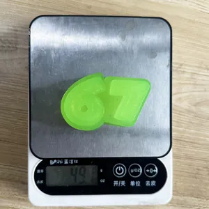 High-quality green 67 digit shaped TPR squishy toy for stress relief on a digital scale