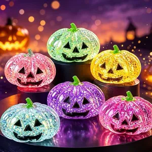 A colorful collection of glitter-filled Halloween pumpkin squishy toys in various shades