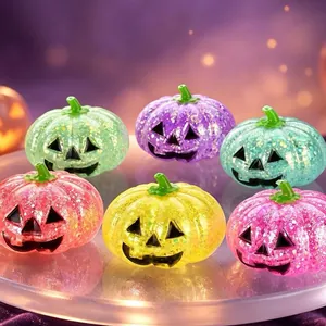 Close-up of vibrant glittery slow rebound Halloween pumpkin squeeze toys in assorted colors