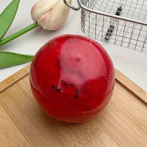 Detailed close-up view of a watermelon slushy squishy ball with realistic seeds and soft texture.