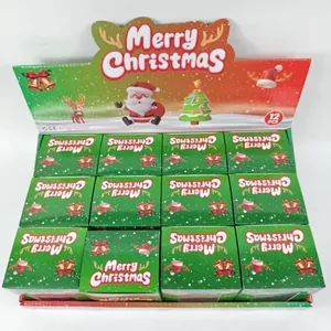 Scatola display di 12 giocattoli antistress a forma di albero di Natale glitterato.