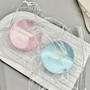 Close-up of translucent pink and blue decompression squishy balls in clear plastic packaging