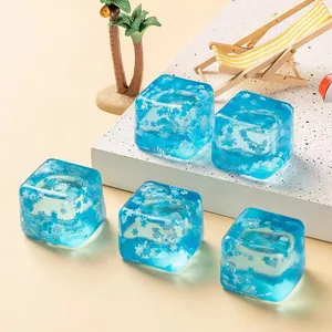 Close-up view of blue ocean-themed cube squishy stress toys with snowflake inserts