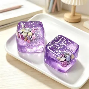 Detailed view of two purple ocean-themed maltose ice cube squishy toys on a tray