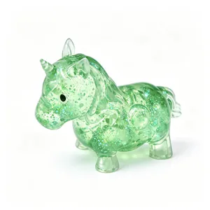 Detail view of a green translucent glitter unicorn squishy toy for stress relief.