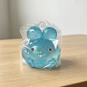 Glittery blue translucent rabbit squishy toy in clear packaging for stress relief