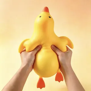 Close-up view of hands squeezing a giant yellow duck slow rebound squishy toy for stress relief