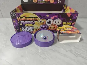 Detailed macro view of a Halloween eyeball squishy toy with purple steamer container