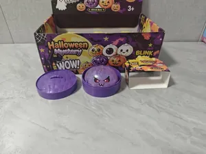 Detail of purple glitter bun squishy toy with Halloween mystery blind box packaging