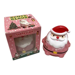 Αξιολάτρευτο ροζ παιχνίδι squishy Άγιος Βασίλης δίπλα στο αντίστοιχο κουτί δώρου.