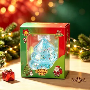 Detail of the blue glitter Christmas tree squishy toy inside its festive window box
