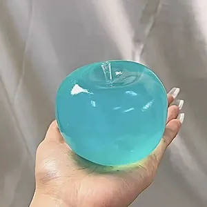 Blue translucent apple squishy toy for stress relief and relaxation held in hand