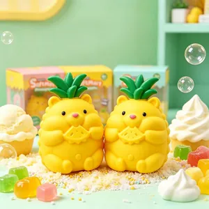 Close-up view of two cute yellow pineapple bear squishy toys holding fruit slices.
