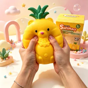 Close-up of hands squeezing a yellow pineapple bear squishy stress relief toy