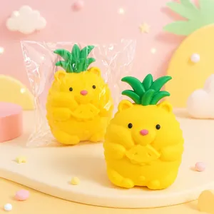 Detailed view of a cute pineapple bear squeeze toy in its plastic packaging and out