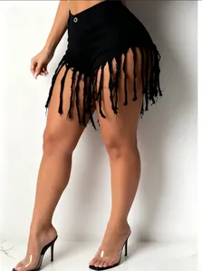 Detailed view of sexy black high-waisted denim shorts with long fringe tassel hem