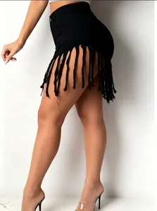 Detailed shot of a black high-waisted denim mini skirt featuring long shredded fringe.
