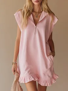 Close-up of a pink sleeveless dress featuring a zipper V-neck and ruffled hem.