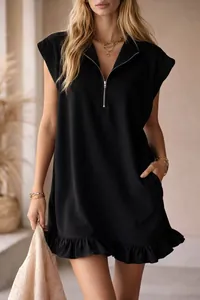 Close-up detail of a chic black sleeveless ruffle hem dress with a zipper V-neckline