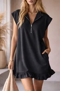 Close-up of sleeveless black dress featuring a zipper V-neckline and ruffled hem detail