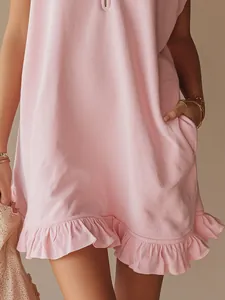 Detail shot of light pink sleeveless dress featuring a ruffled hem and side pockets