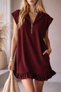 Detailed view of a burgundy sleeveless V-neck dress with zipper and ruffle hem detail