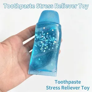 Detailed view of blue glitter toothpaste squishy toy being squeezed by hand