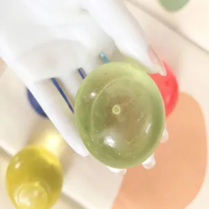 Handmade green translucent maltose squeeze toy ball for stress relief and sensory play