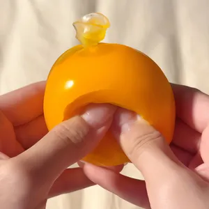 Yellow crispy squeeze stress relief ball being pinched by hands for anxiety relief