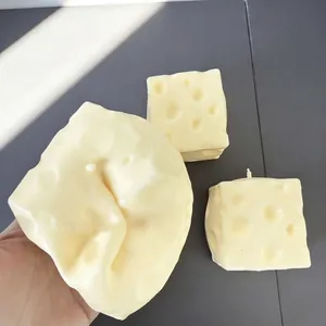Close-up of handmade cheese-shaped squishy toys being squeezed for stress relief and fun
