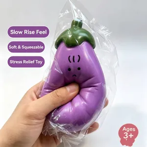 Macro view of hand squeezing soft eggplant squishy stress relief toy in packaging