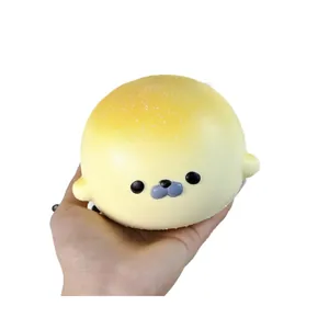 Detailed close-up view of a soft yellow seal slow rebound squishy toy held in hand