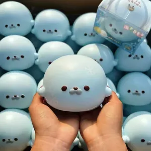 Soft blue seal squishy toy with snowflake patterns held in hands for stress relief