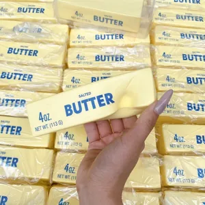 Close-up of simulation butter stick squishy toy with realistic yellow wrapper texture.
