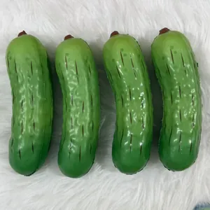 Macro view of four realistic green pickle squishy toys resting on a soft white plush rug