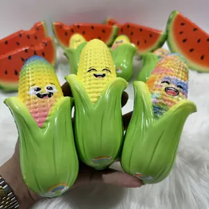 Detail shot of cute corn squishy toys with smiley faces and watermelon props.