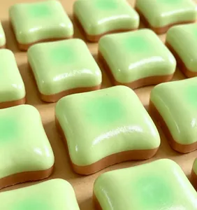 Close-up of green glazed butter toast squishy toy with realistic soft texture and shine