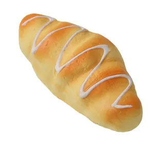 Close-up detail of simulation bread squishy toy with white icing swirl