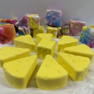 Detailed view of yellow simulation cheese squishies and colorful marble patterned cubes