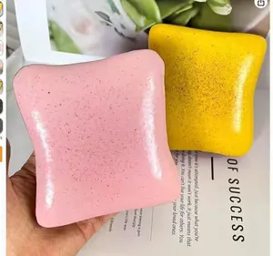 Close-up of pink and yellow toast-shaped squishy toys with realistic texture for stress relief.