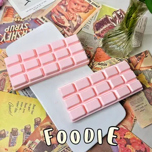 Close-up of two pink chocolate bar shaped slow rebound squishy stress relief toys