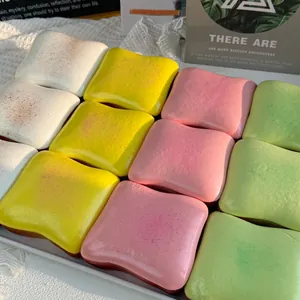 Detailed view of colorful square slow-rising butter toast squishies arranged on a tray