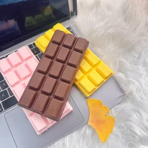 Realistic chocolate bar squishy toy for stress relief in brown, yellow and pink.