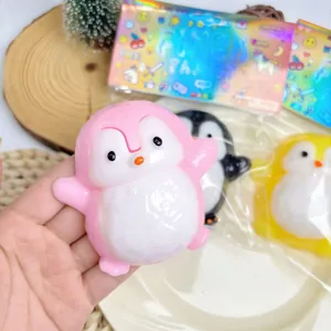 Macro detail of a pink penguin squishy toy being squeezed for slow rebound stress relief
