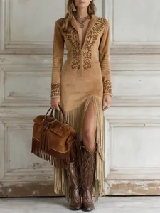 Detail view of vintage ethnic suede dress with fringe hem and floral embroidery accents