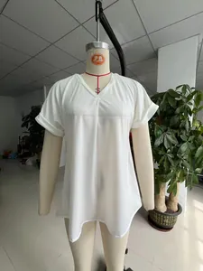 Detailed close-up showing the white V-neck and rolled sleeves of this pleated women's top