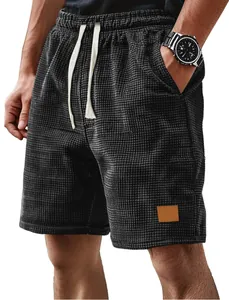 Close-up of men's casual waffle knit shorts with drawstring and grey checkered pattern