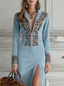 Close-up view of vintage ethnic floral print and zipper detail on light blue tassel dress